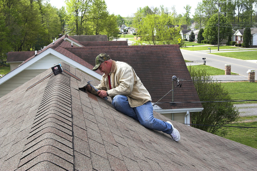 man replacing the roof